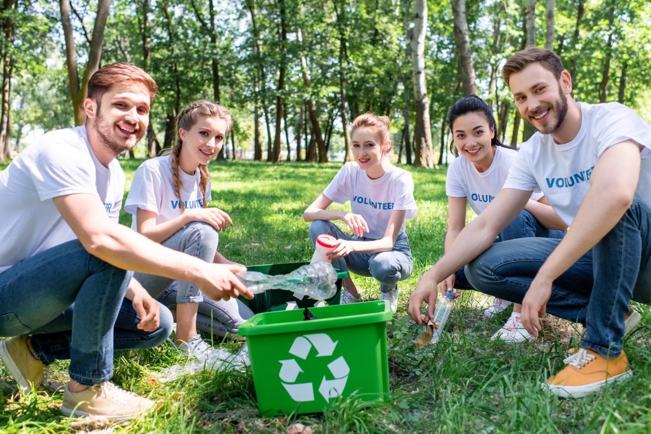 young-volunteers-with-green-recycling-box-cleaning-park